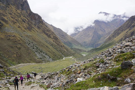 Hikers in mountain valley of mist